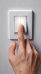 Hand turning on a light switch