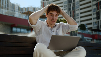 Happy Caucasian man business city freelancer working laptop computer win victory emotional male...