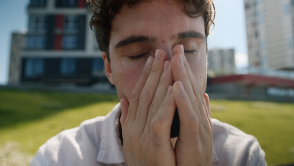 Close up tired unhappy Caucasian man covering face hands grief problems exhausted employee work...
