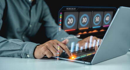 A person interacts with a laptop displaying futuristic data analytics and graphs through a...