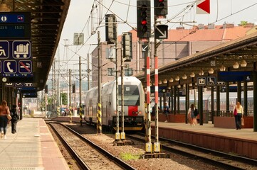 Red train on the track. Fast train. Railway station.