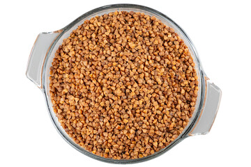 Top view of raw buckwheat groats on transparent glass plate. Isolated object.