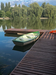 Calm Lake Scene with a Wooden Dock and Suspension Bridge