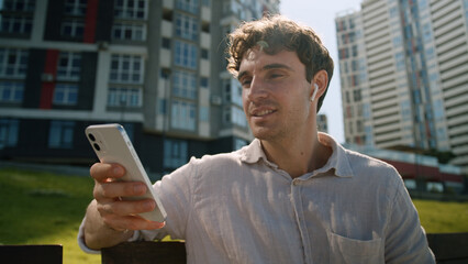 Caucasian man listen music headphones enjoy sound businessman male guy city listening song...