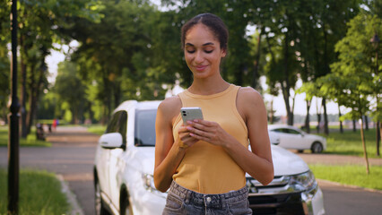 African American woman using mobile phone smartphone cellphone car driver smile auto vehicle...