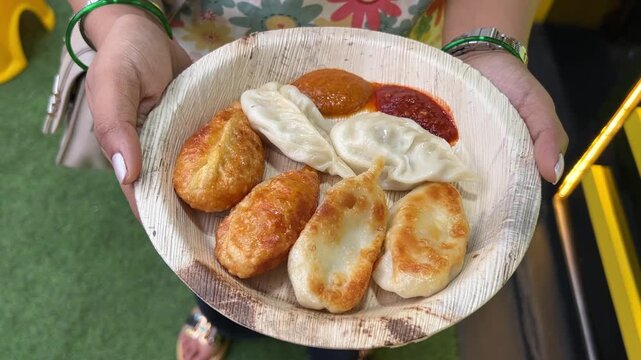 Kothey momo served with spicy Bhutanese sauce in a sugarcane recycled plate