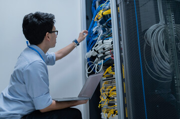 Computer engineer is setting up network in server room,Systems Maintenance Technician,Male engineer...