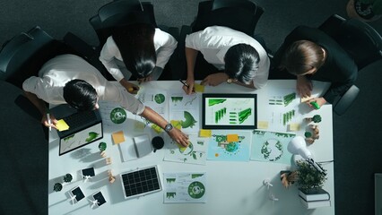 Top view of executive manager hold tablet display clean energy at meeting. Aerial view of business...