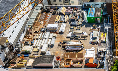 Bright and organized construction supplies stored on shelves under clear blue sky at a busy...