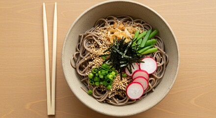 Exquisite soba noodle bowl presentation, adorned with fresh vegetables, radish, sesame seeds, next to wooden chopsticks.