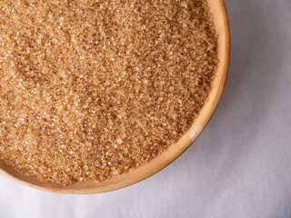 Organic Light Brown Sugar on wooden board.