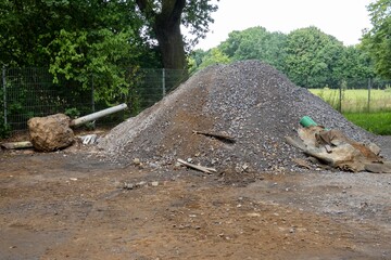 Construction debris and large pile of gravel at building site