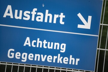 German road sign indicating exit and oncoming traffic