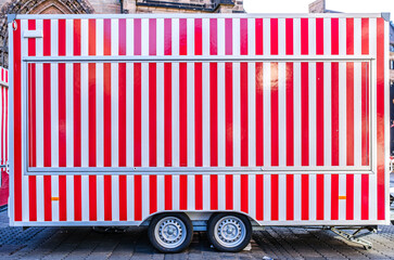 Colorful striped food stall located in a vibrant marketplace ready for a busy day serving local...