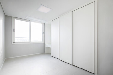 A neat room decorated entirely with white furniture