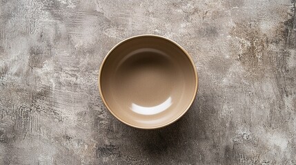 Simple beige bowl on a textured brown surface, perfect for serving a variety of dishes during mealtime or as table decor