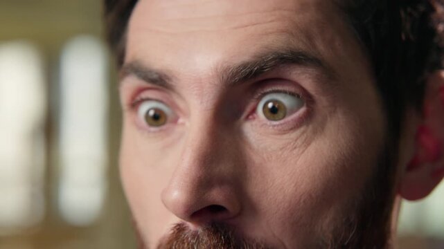 Close up shocked business man big eyes staring mobile phone screen shock wonder amazed stunned reaction message news in office afraid excited businessman male face emotion astonishment unbelievable