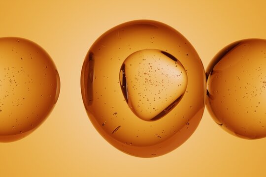 Macro shot of glossy golden spheres with visible internal bubbles, isolated on vibrant yellow background, abstract 3D molecular or cosmetic design for science, biology, chemistry or luxury concepts