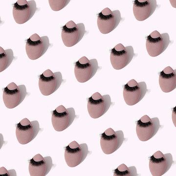 Makeup sponges with eyelashes repeated in soft background