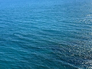 Blue calm ocean water background.