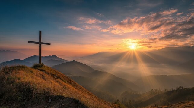 Scenic mountain landscape at sunrise with a wooden cross on a grassy hilltop. - Powered by Adobe