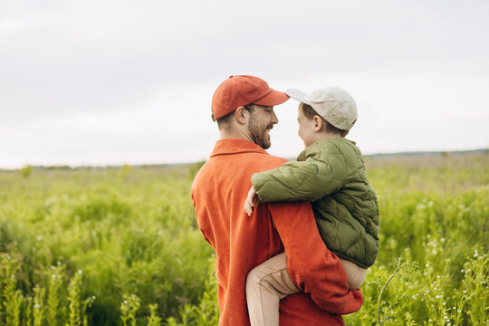 Father and son sharing a moment in a sunny field