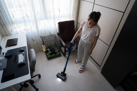 Woman vacuuming in a tidy home office space