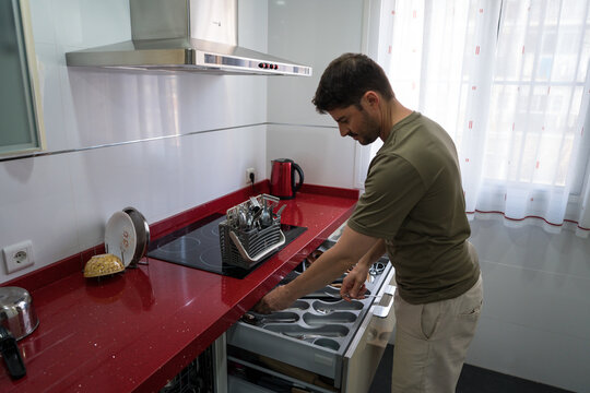 Man organizing kitchen for effective household chores