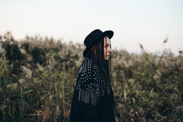 Woman in profile amidst nature during sunset
