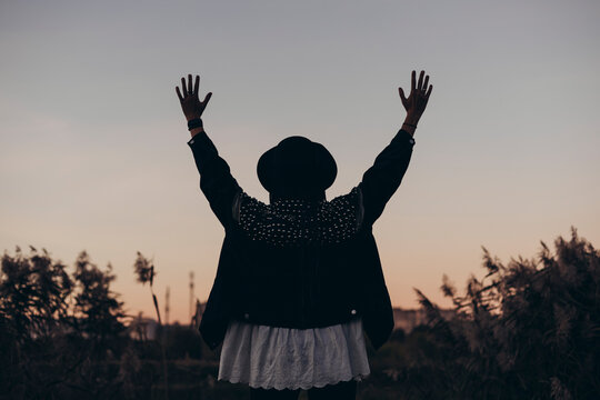 Silhouette of a woman embracing sunset beauty