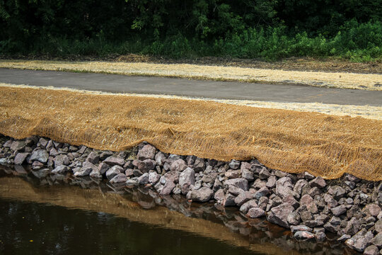 erosion blanket and riprap by a creek and trail. restoration and environment landscape background or design element.