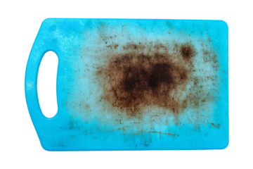 a blue cutting board with a brown substance on it