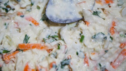 Close-up of mixed vegetable batter with carrots, cabbage, and herbs ready for frying