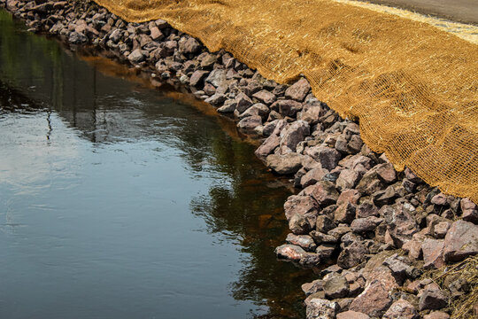 erosion blanket and riprap by a creek. restoration and environment landscape background or design element with copy space