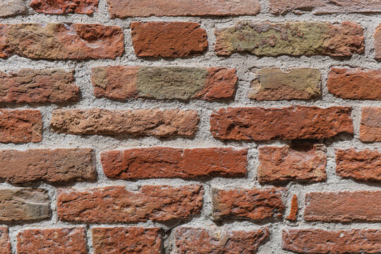 Fototapeta Close-up of a red brick wall with rough texture detail