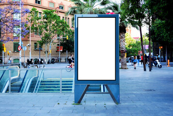 blank ad panel. billboard display. empty white lightbox sign at urban street Metro station. billboard mockup. glass and metal structure. urban street traffic setting with red bus. outdoor advertising.