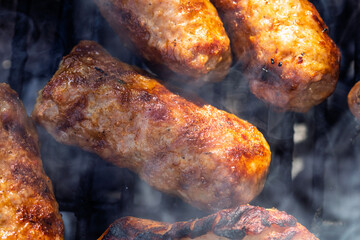 Pork chops, steak, sausages on barbecue grill