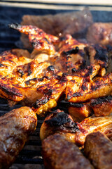 Pork chops, steak, sausages on barbecue grill