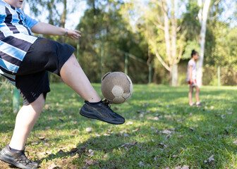 Kids playing soccer on a sunny day in Brazil
