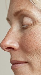Obraz premium Mature woman's profile revealing weathered skin, soft wrinkles, natural freckles, embodying graceful aging and authentic beauty