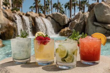 vibrant and colorful collection of top  famous cocktails displayed elegantly by poolside or ocean backdrop