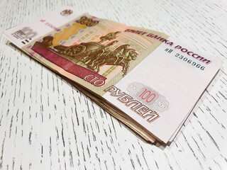 100 ruble bills on the table. Ruble banknotes, paper money, finance.