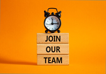 Join our team symbol. Wooden blocks with words Join our team. Beautiful orange background with...