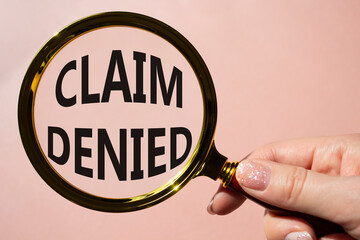 Claim denied symbol. Magnifying Glass with Concept word Claim denied. Beautiful pink background....