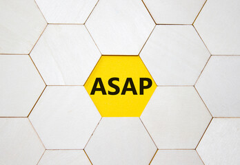 ASAP symbol. Concept word ASAP on wooden comb puzzle. Beautiful yellow background. Business and...