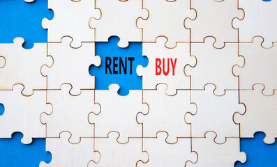 Fototapeta premium Rent or Buy symbol. Concept word Rent or Buy on wooden puzzle. Beautiful blue background. Business and Rent or Buy concept. Copy space