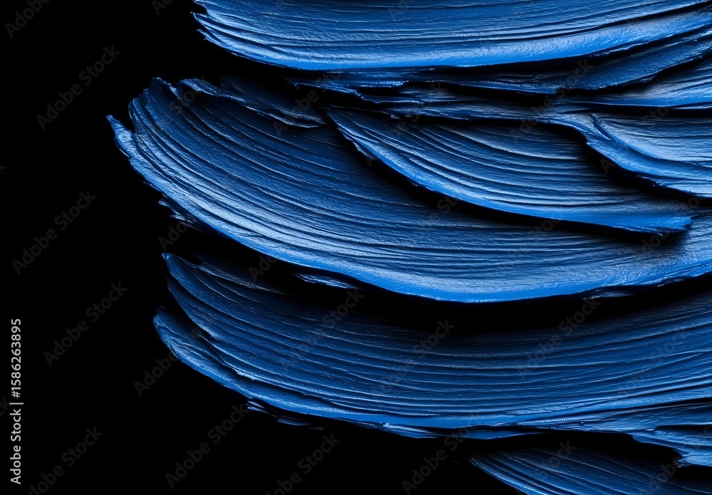 Poster layered blue paper sheets creating abstract waves and curves against black background, artistic macr