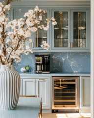 modern kitchen featuring blue cabinetry, marble backsplash, and stainless steel appliances. elegant design includes wine cooler and decorative flowers, creating stylish