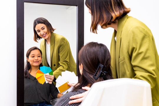Color consultation in front of mirror with swatch cards