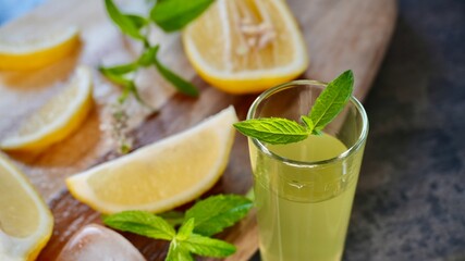 Glass of fresh homemade lemonade with lemon slices, mint, and ice cubes. Refreshing summer drink perfect for healthy lifestyle, detox, or beverage themes.